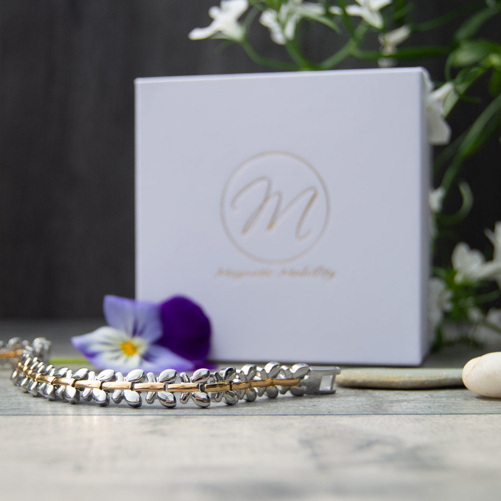 Buddleia Twighlight - Silver and Gold Coloured Magnetic Bracelet  front view - image shows the bracelet in front of luxury white gift box