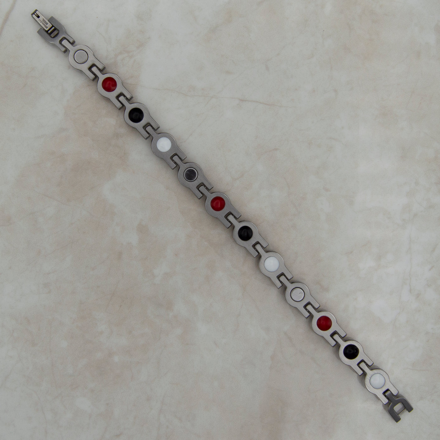 Back view of our April birthstone Magnetic bracelet for women as part of the Triple gift set - shows the 4 health elements : Negative ions, FIR elements, Germanium and Neodynium magnets