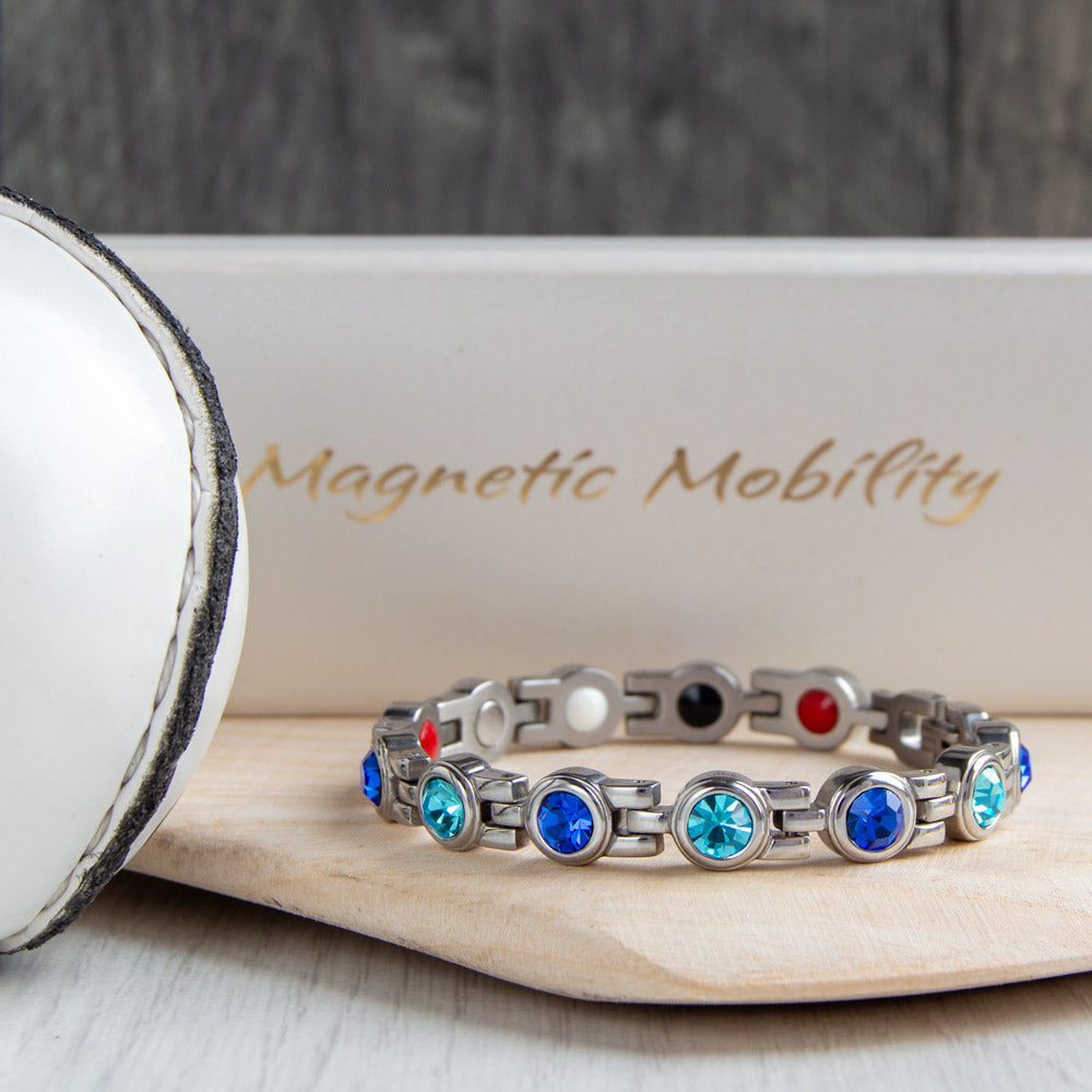 Dublin County GAA Inspired Women's Magnetic Bracelet showcased on a hurl. A fusion of county pride and magnetic therapy benefits, aiding in relief from migraines, sports injuries, and more.