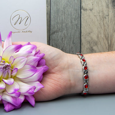 Janurary Birthstone Bracelet on womans wrist. Contains 4 Health elements for your wellness.
