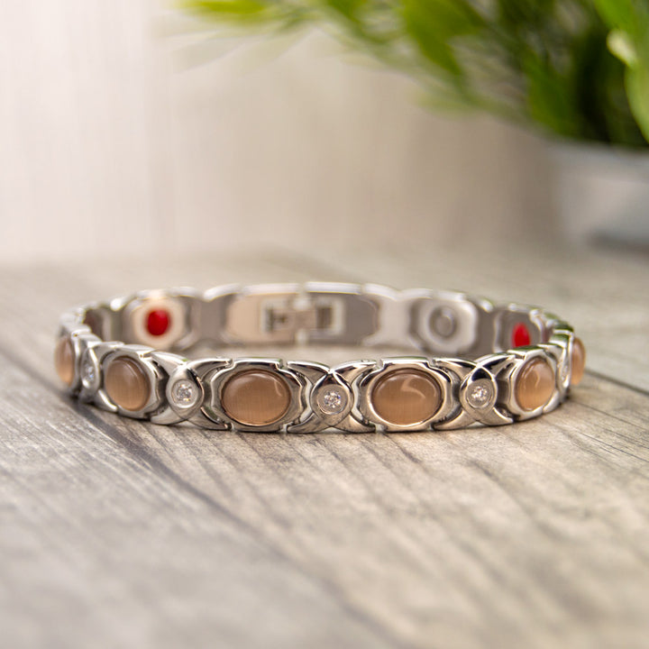 Silver Stainless steel Magnetic bracelet with opals and white crystal. Magnetic bracelet for women with 4 health elements in the back. The Health elements are great fro arthrits, migraine, back pain etc